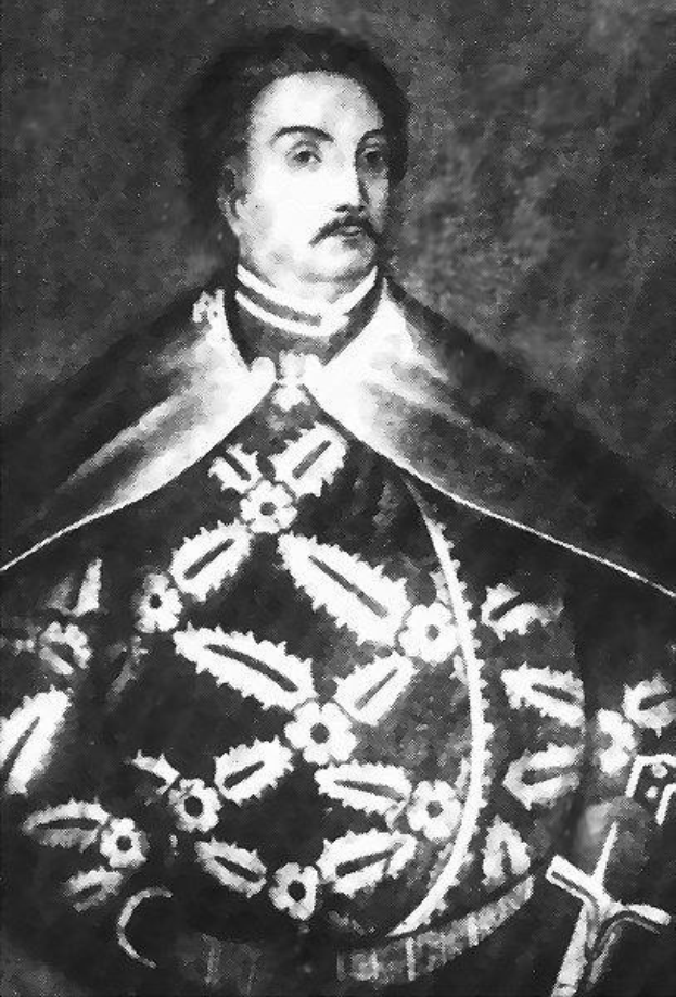 Schwarzes und weißes Foto von Papst Johannes Paul II. in Priesterrobe, der eine schwarze Robe mit weißem Kragen und Manschetten trägt und die Hände verschränkt hält, mit ernster Miene und direktem Blick.